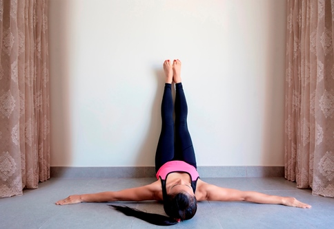 Yoga en pared para estirar las piernas y la espalda baja